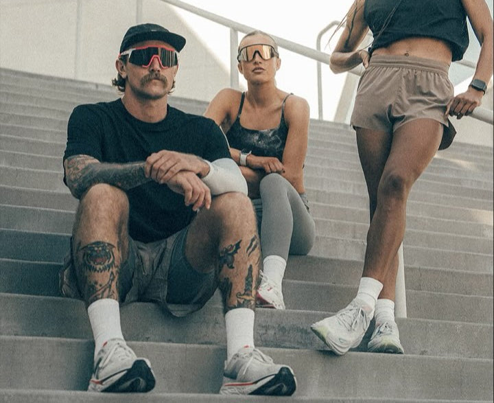 Three people sitting on steps outdoors with 'Speedcraft' branding.